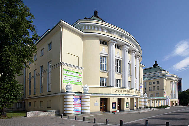 Yellow multiple storey building with white structural elements and decorations.