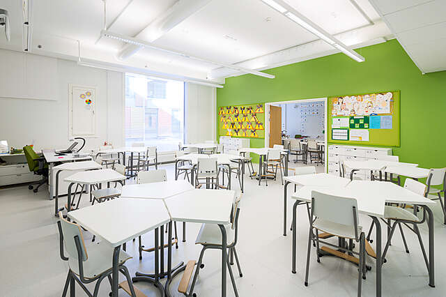 Modern classroom with green wall.