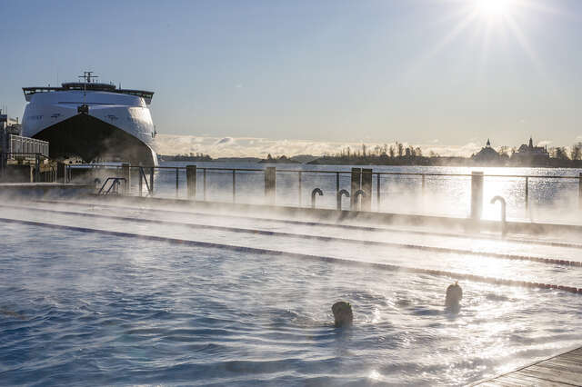 Swimming pool next to a cruise ship.