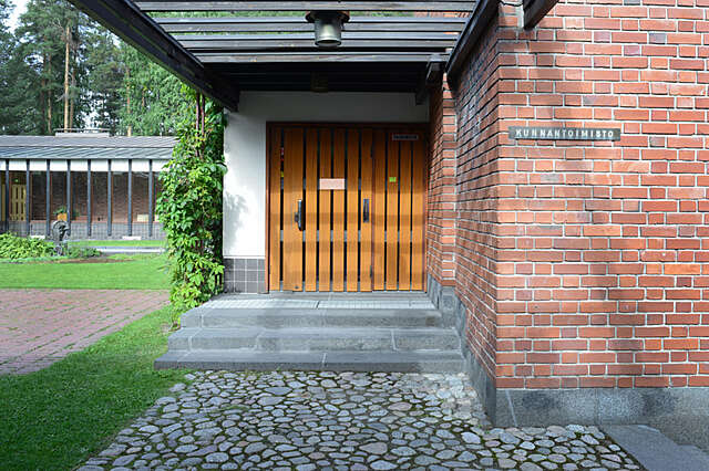 Wood panel door on a red-brick building.