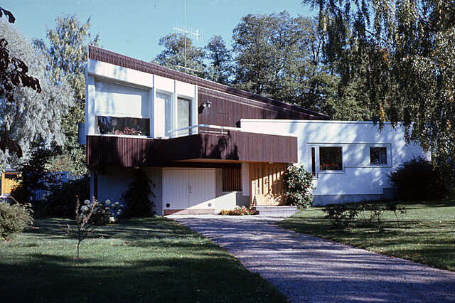 Building facade with white and wooden elements.