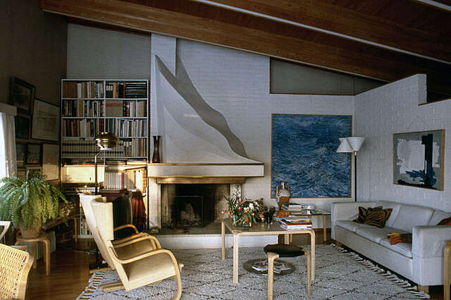 Living room interior with tile and wood elements and a fireplace.