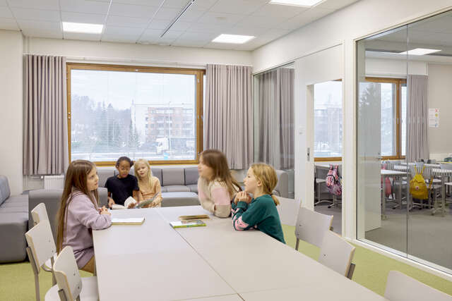 Small children gathered around a table.