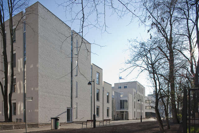 White-tile university building facade.