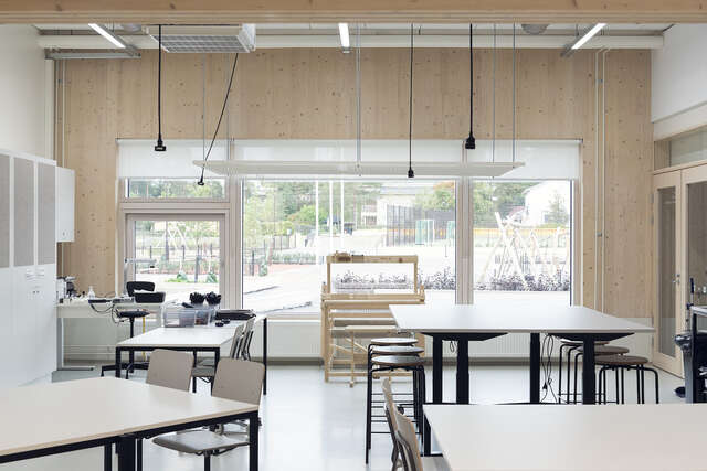 Classroom with tables and chairs looking outside.