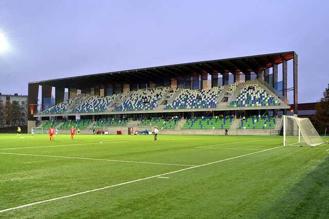 Sports arena and spectator stands from an angle during a game.