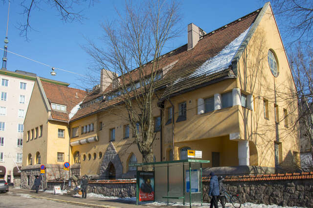 Yellow hospital facade with white details.