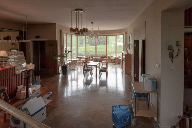 A round bay with evenly distributed, wooden-framed windows.