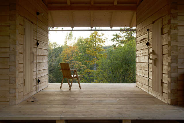 Sheltered terrace with a wooden chair.