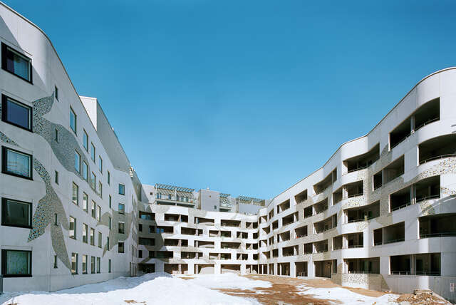 lIght façade with mosaic details and wavy walls