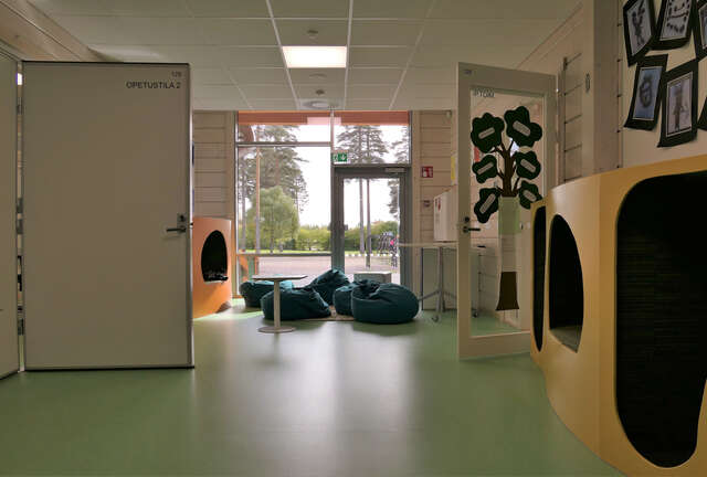 Light interior with a green vinyl floor and wooden walls.