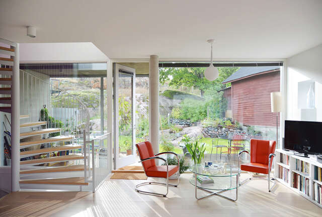 The large windows in the living room let much light in the room.