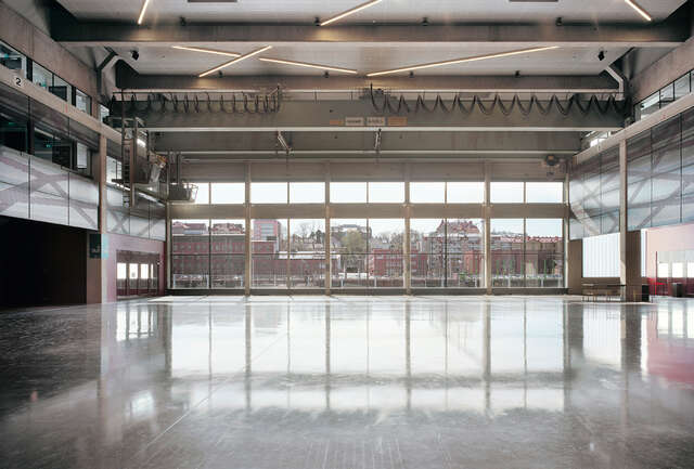 Industrial grey-toned view through large windows to railyard