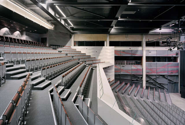 Side view from the auditorium showing seats, ceiling and wall elements