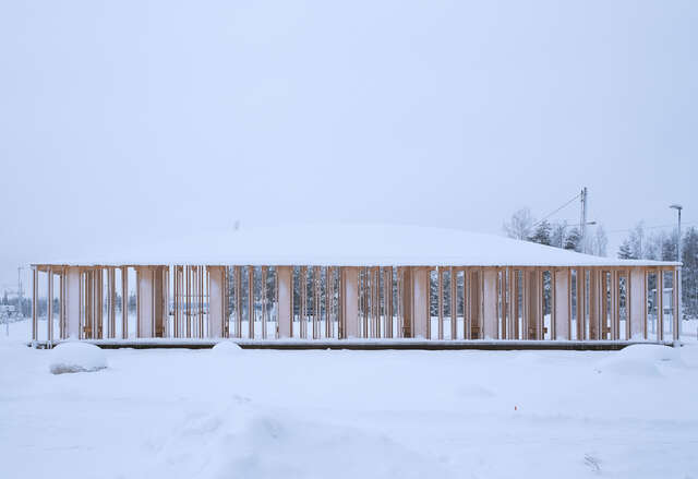 A wooden structure in a snowy field
