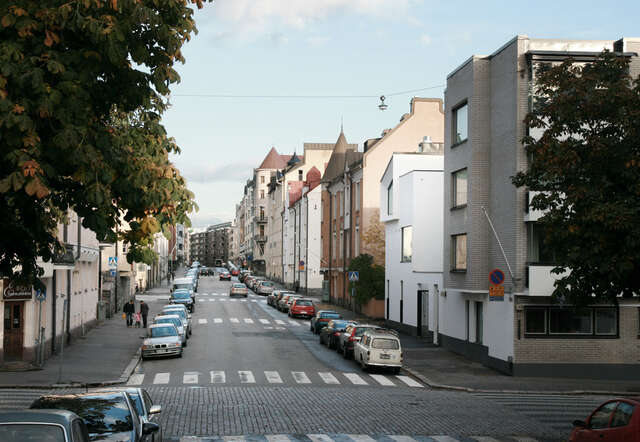 White town-house type buildings merged in the street of art nouveau apartment houses
