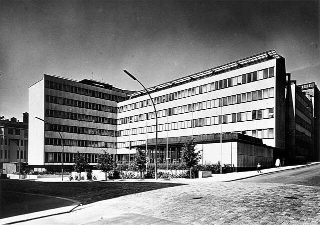 Facade of an L shaped stone building.