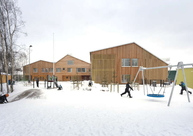 Winter, snow on the ground, three timber-clad gables in the rear, children playing