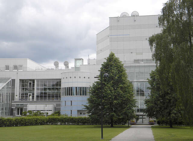 Building facade with white and pale blue ceramic tiles.