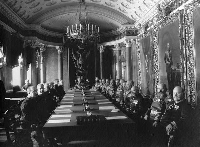 Old black and white picture of important and influential men sitting at a long table.