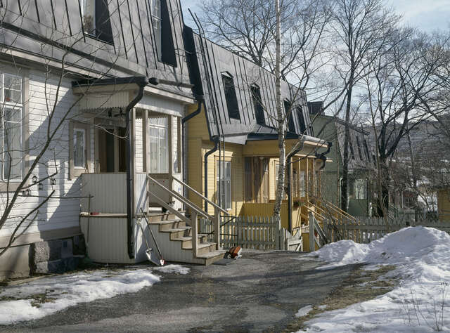 White and yellow wooden houses next to each other.