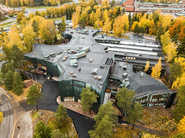Aerial image of Dipoli and its autumnal surroundings.