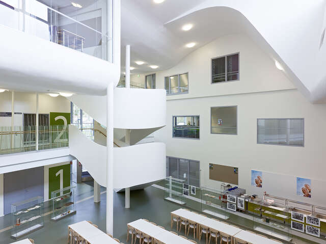 White curved staircase next to the canteen.