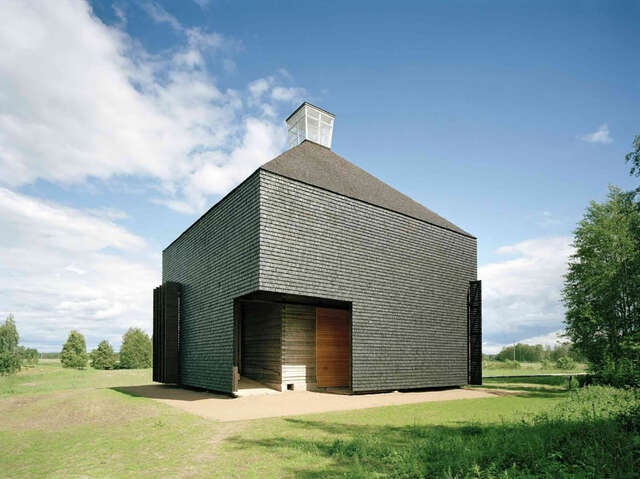 Contemporary wooden church in the middle of a grassfield