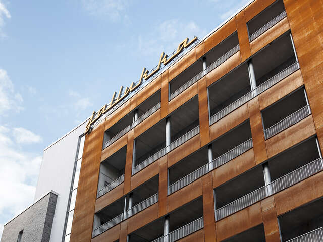 Rust colored building with a jallukka sign at the top.