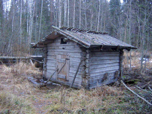 Photo of an grey wooden log building
