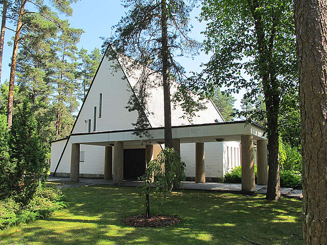 Entrance colonnade and the chapel in-between greenery.