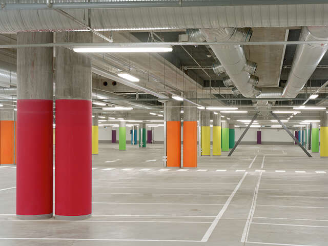 Inside parking lot with colorful columns.
