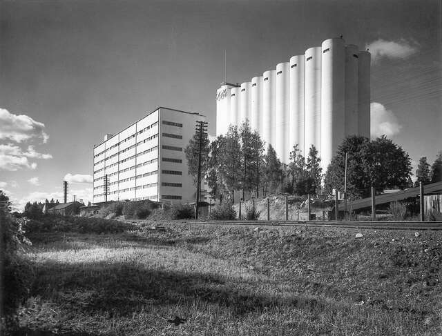 Functionalist mill and its surroundings, railways in front of the building.