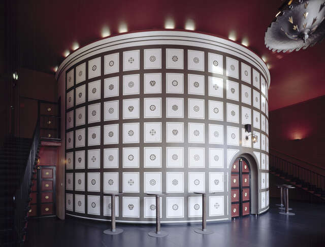 decorative wall with a square pattern in a dark red room