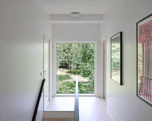 A hallway in a detached house with a large window