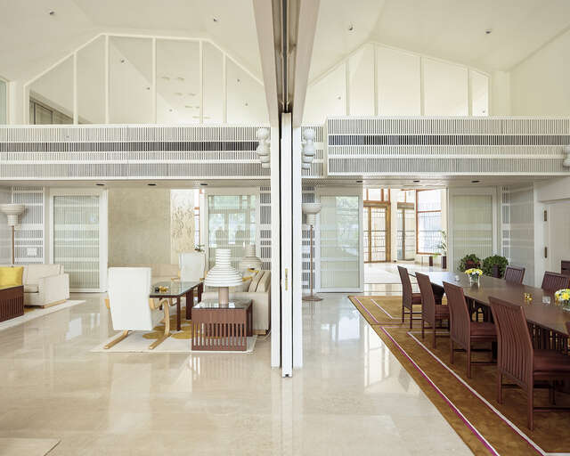 Different rooms of the embassy; a living room and a dining room with a very long table.