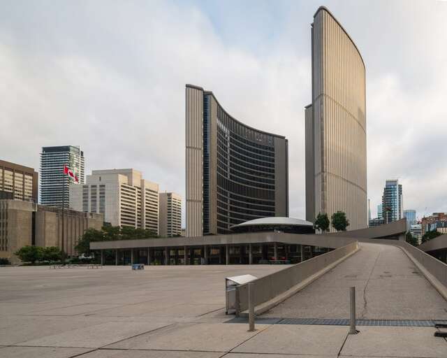 A square and a ramp in front of a building with two towers
