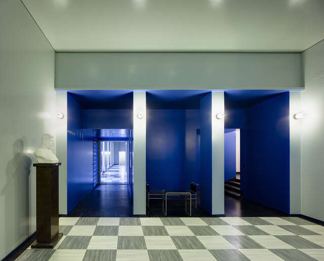 Three blue spaces branching off from a white room.