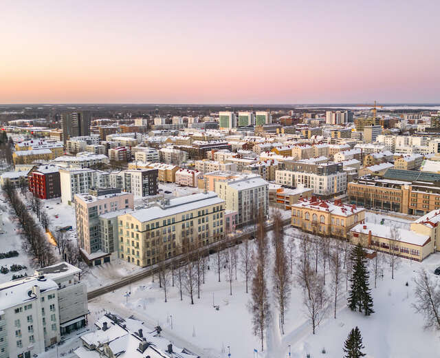 An aerial view of apartment buildings in a dense city area during wintertime.