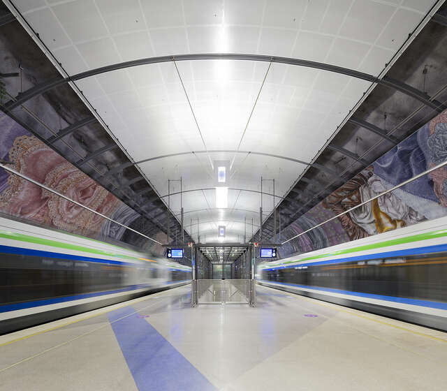 Two trains moving away from the station.