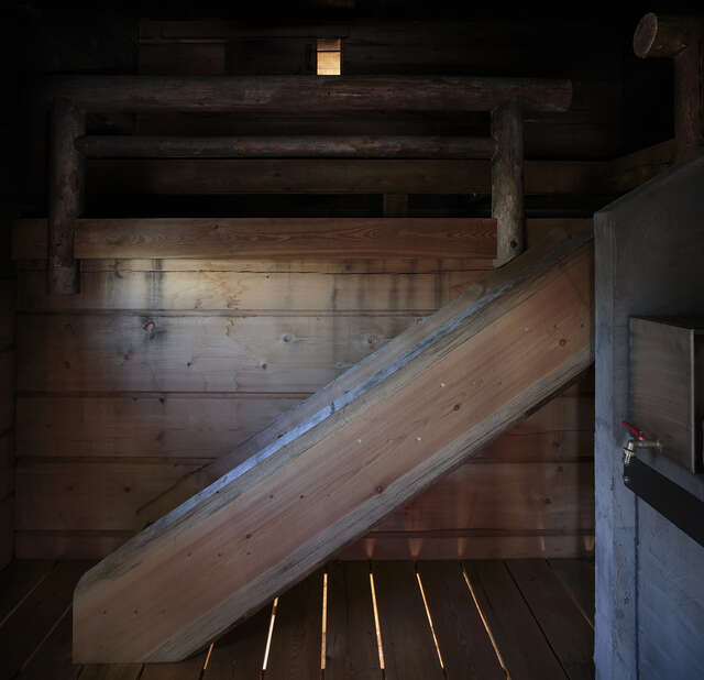 Darkened interior of the smoke sauna.