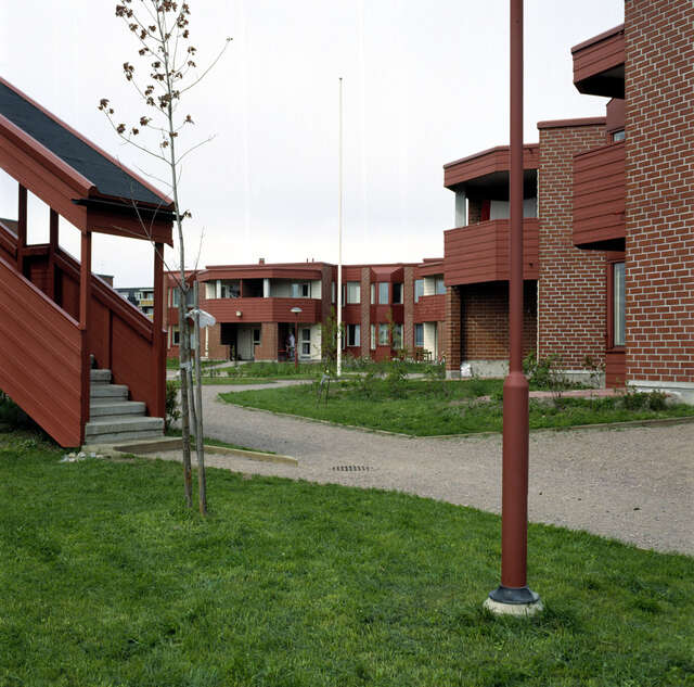 Yard side facades: the ground floor flats have gardens, and the first-floor flats have covered balconies.
