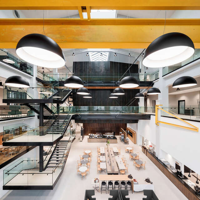 Foyer with open staircase on the left, large lamps in front of the picture.