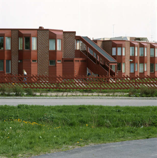 The street facades have angular bay windows to soften the look of the buildings. The precast concrete panels are facing brick-tiles and horizontal boards.