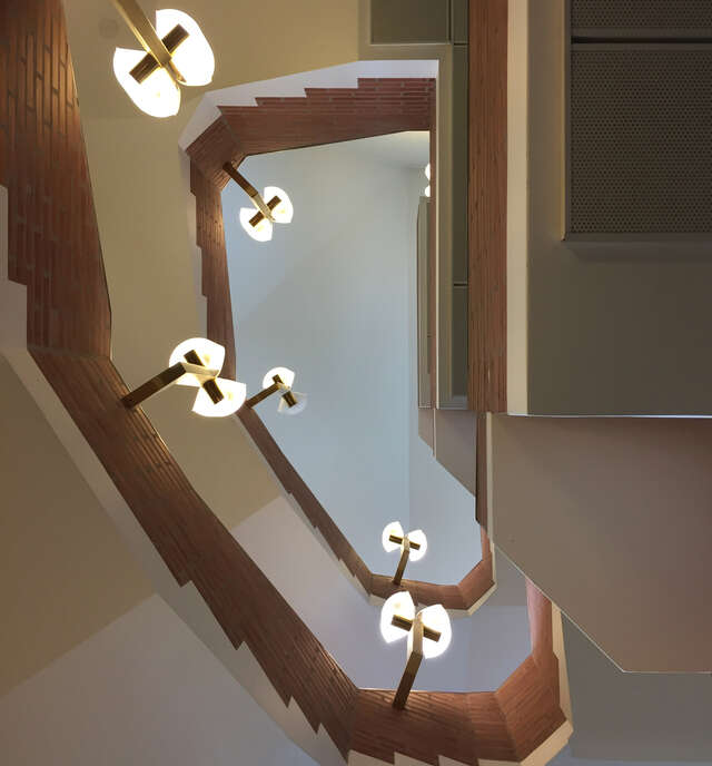 Staircase made of white plaster and red bricks.
