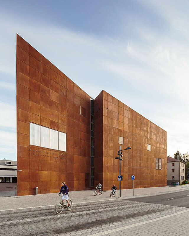 Rust colure building with pointy edges to the sides.