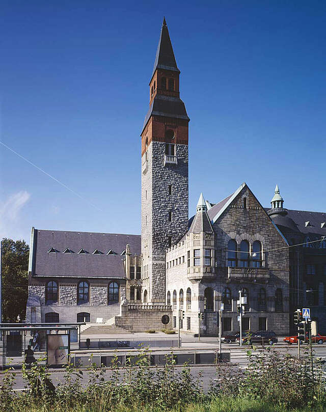 Granite façade building with a tall tower in the centre