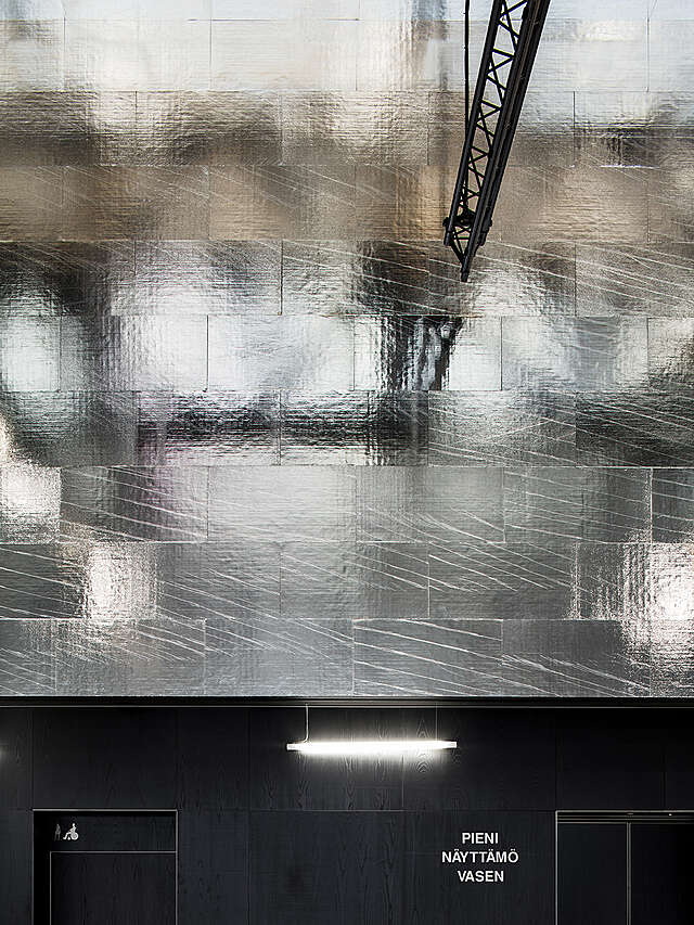 Metallic wall reflects right.