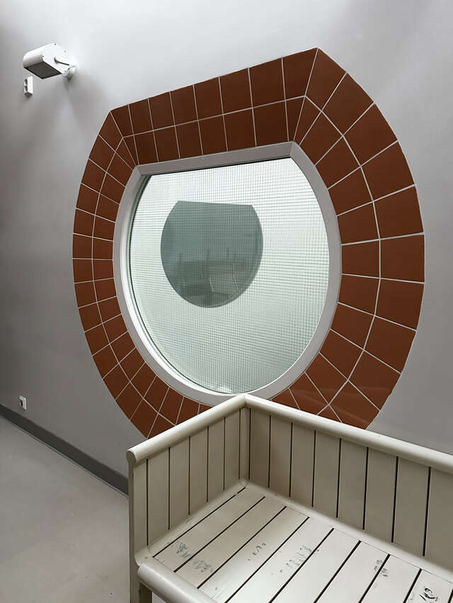 Round window surrounded by brick outline.