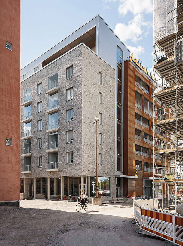 Jallukka apartment building with a tile and metal facade viewed at from an angle.